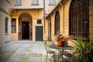 a patio with a table and chairs in front of a building at Apartment Vitale in Bologna