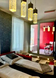 a bedroom with a bed and a window and lights at Apartmánik v tichom nádvorí - free parking in Bratislava