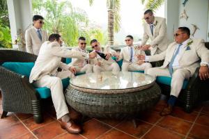 a group of men in suits sitting around a table at Luxury Villa Bonita Sleep 50 + in Isabela +111 photos