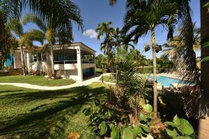 a house with a swimming pool and palm trees at Luxury Villa Bonita Sleep 50 + in Isabela