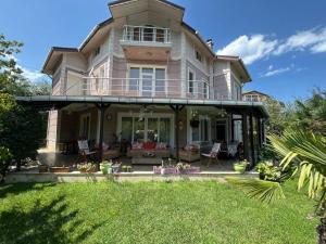 a large house with a balcony and a yard at Villa Elysium in Gebze