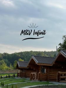 a log cabin with the words mexiki institute in front of it at M&V Infinit in Sălătrucel