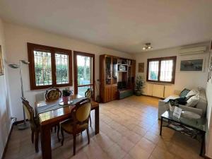 a living room with a table and a couch at Appartamento Immerso nel Verde in Borgo Malpasso