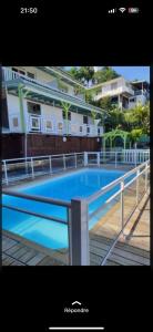a picture of a swimming pool next to a building at Residence Chez Marraine Maison BERTILI in Le Gosier