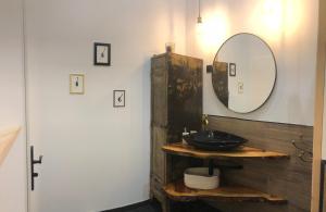 a bathroom with a sink and a mirror at L inarretable studio independant in Cubnezais