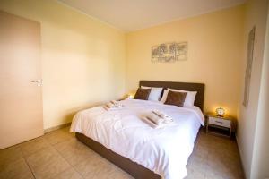 Postel nebo postele na pokoji v ubytování Artemide Apartment