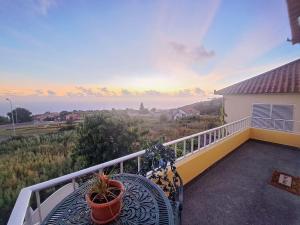 a balcony with a bench and a view of the ocean at Calheta Countryside in Calheta