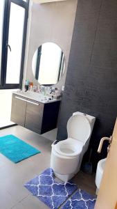 a bathroom with a toilet and a sink and a mirror at Tamares in Casablanca