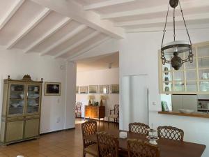 a kitchen and dining room with a table and chairs at Mediterranean house with beautiful garden in Karlovasi