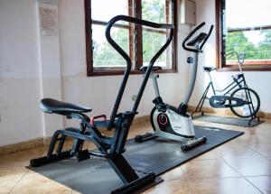 a gym with two exercise bikes and a treadmill at Luxor garden apartments Accra Ghana in Accra