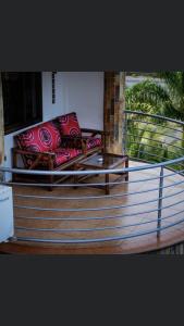 a couch sitting on top of a balcony at Luxor garden apartments Accra Ghana in Accra