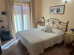 a bedroom with a bed and a large window at Il Timone Loreto in Monterosso al Mare