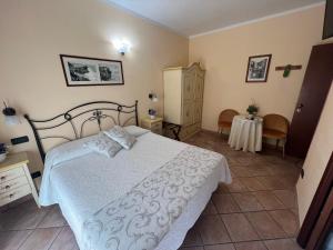 a bedroom with a white bed and a table at Il Timone Loreto in Monterosso al Mare