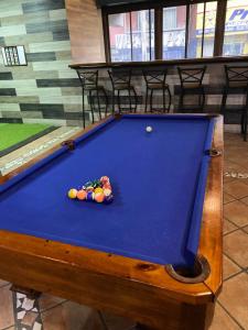 a pool table with balls on top of it at Alajuela Backpackers Airport Hostel in Alajuela City