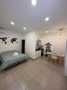 a bedroom with a bed and a table and a kitchen at Luxury Apartments in Mendoza