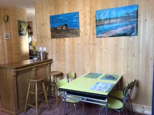 a bar with a table and chairs in a room at La cabine le Courlis in Le Tréport