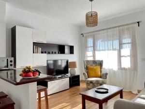a kitchen and living room with a table and a couch at O sole mio en Playa honda in Playa Honda +19 photos