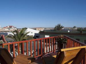 a wooden balcony with a view of a city at Wildhorses B&B and Self Catering in Lüderitz