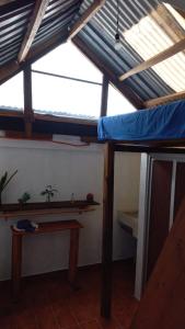 a room with a loft bed and a table at Casa Nina in San Cristóbal de Las Casas