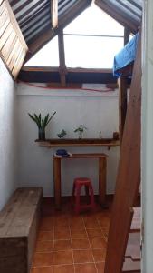 a room with a table and a stool in a room at Casa Nina in San Cristóbal de Las Casas