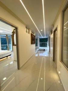 a hallway of a house with white floors and ceilings at Hostal Balcon del Cielo in Baños