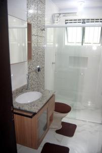 a bathroom with a sink and a shower at Apto Meia Praia in Itapema +20 photos