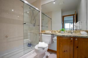 a bathroom with a shower and a toilet and a sink at Bright Multi-Level Home in Whistler +22 photos