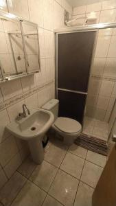 a bathroom with a toilet and a sink at Oro Hospedaria in Ouro Preto