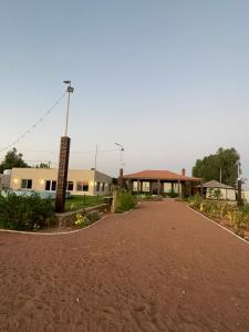 a building with a dirt road in front of it at Golden Sands Resort in Qibāʼ
