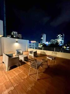a patio with chairs and a table on a roof at Great Apartment with Private Terrace near Centro Cívico in Tegucigalpa