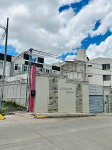 a building on the side of a street with a fence at Great Apartment with Private Terrace near Centro Cívico in Tegucigalpa