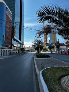 an empty street in a city with tall buildings at Dormitorio en San Miguel in La Paz