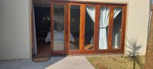 a sliding glass door of a house with a bedroom at Royal Inn Room 2 in Kimberley