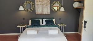 a bedroom with a large bed with two side tables at Royal Inn Room 2 in Kimberley