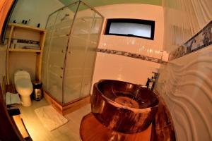 a bathroom with a copper sink and a toilet at Sendero del Zorro, Km 41,5 ruta N-55 in Chillán