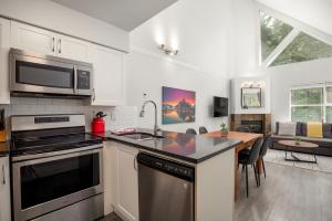 a kitchen with a sink and a stove top oven at Great Location with Pool and Hot Tub by Harmony Whistler in Whistler