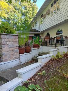 a house with steps leading to a porch with potted plants at White Birch Inn in Sturgeon Bay