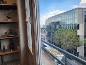 a window with a view of a building at L'Essentiel - Appartement lumineux proche de tout in Arcueil