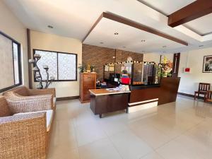 a room with a couch and a table and a counter at DIAKOPES INN in Puerto Princesa City