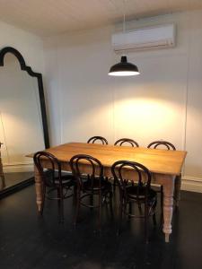a dining room table with four chairs around it at Trelawney Farm Mudgee - Rural retreat in Mudgee