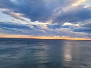 a view of the ocean under a cloudy sky at Amfora apartments in Lezhë +4 photos