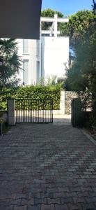 a fence on a brick walkway in front of a building at All Seasons Villa 3 in Golem