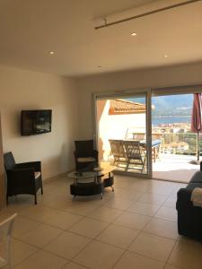 a living room with a couch and a table at punta di prunetu in Propriano