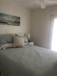 a bedroom with a bed with two pillows on it at Conch Club Cottage in Head of Bay +13 photos