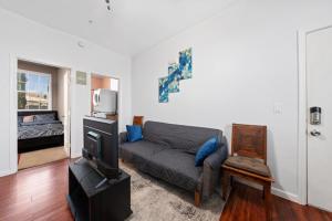 a living room with a couch and a tv at Cozy 1 bdr/1br near downtown in Sacramento