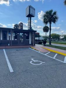 a parking lot in front of a gas station at LIBERTY INN in Kissimmee