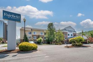 a sign for a hotel in a parking lot at Fairfield Inn & Suites Cherokee in Cherokee