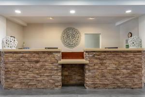 a bar in a lobby with a brick wall at Fairfield Inn & Suites Cherokee in Cherokee