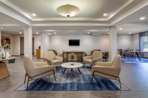 a waiting room with chairs and a table and a tv at Fairfield Inn & Suites Cherokee in Cherokee