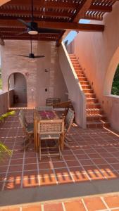 a patio with a table and chairs and stairs at Casa Liquen in Chacala